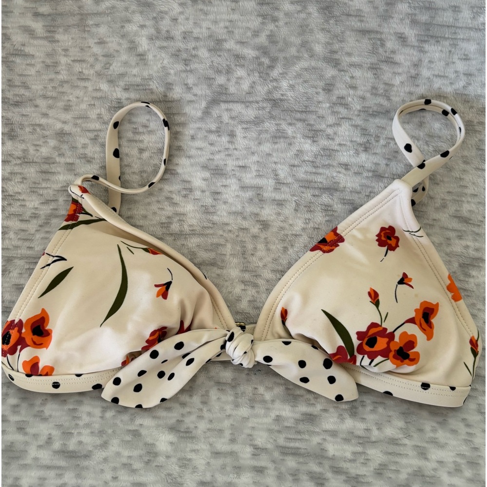 A medium cream, black and orange bikini top with orange flowers